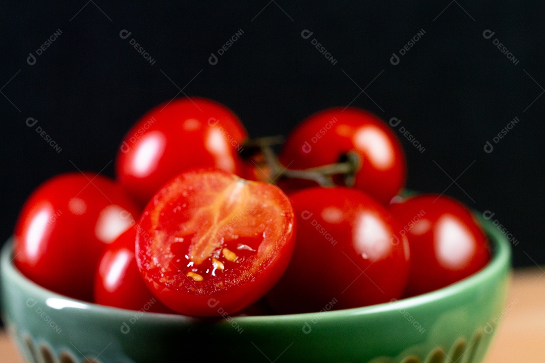 tomates sobre uma mesa de madeira com fundo preto