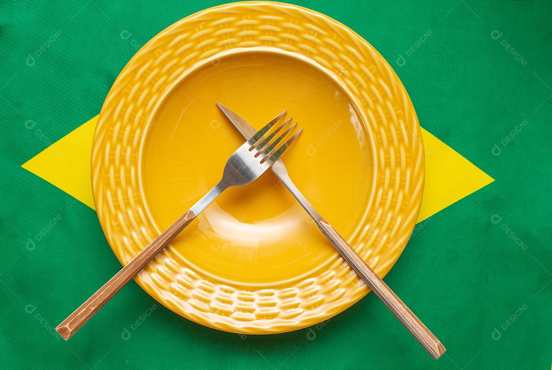 prato vazio com talheres sobre a bandeira brasileira