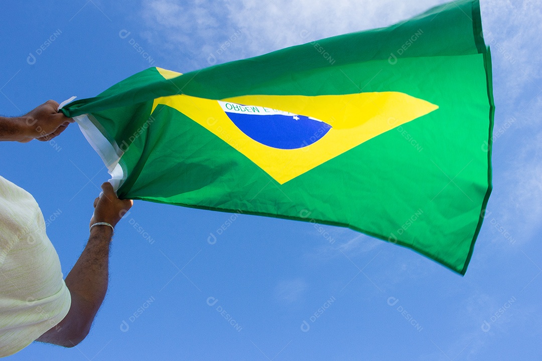 homem segurando a bandeira do brasil em suas mãos
