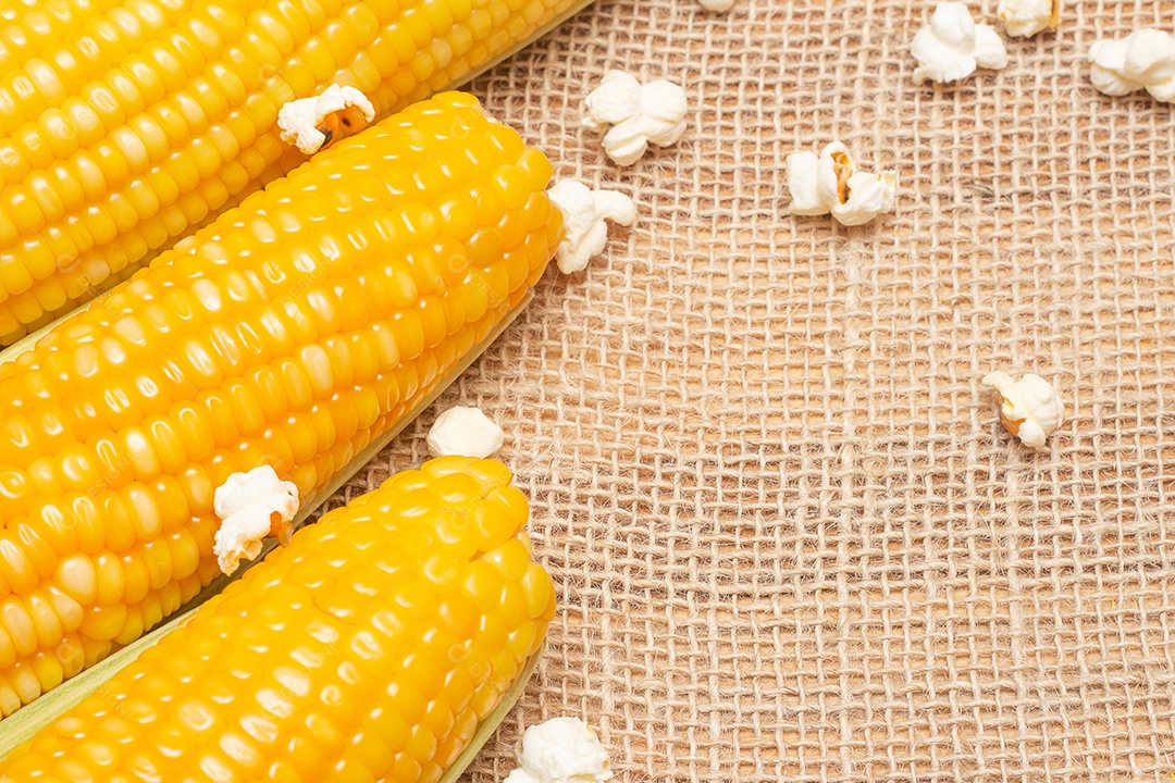 Brazilian party snacks with corn and popcorn on straw background