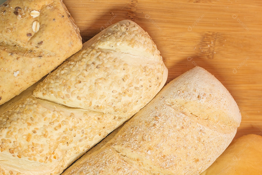 quatro tipos de pães em uma mesa de madeira