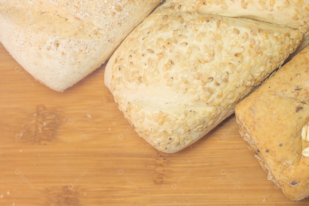 three types of bread on a wooden table