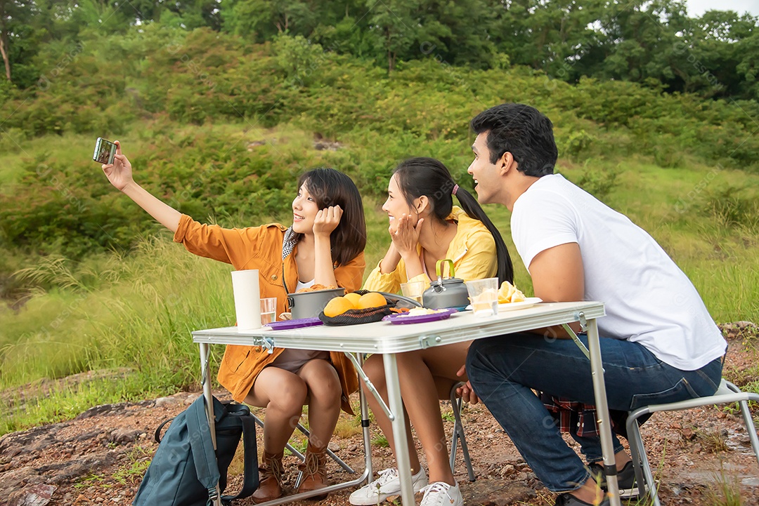 Grupo de amigos homens e mulheres colocou uma mesa de piquenique