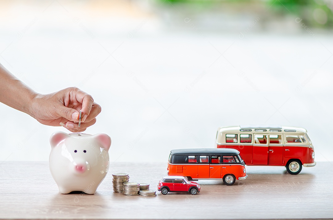 Mão de homem joga moeda no cofrinho