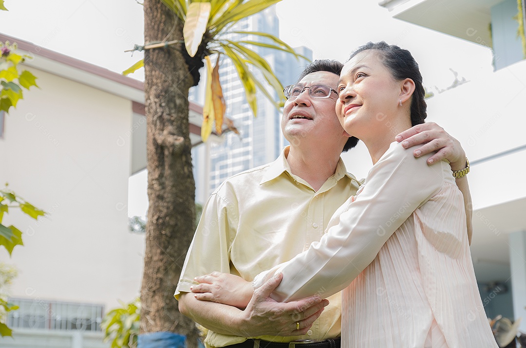 Casal sênior asiático sorrindo, feliz, em casa vivendo uma boa vida