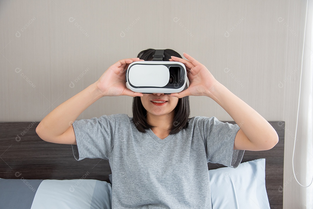 Mulher segurando o jogador VR na cama