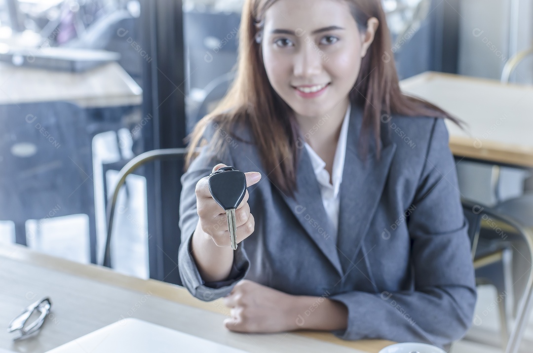 mulher de negócios segure a mão direita chave e sorria