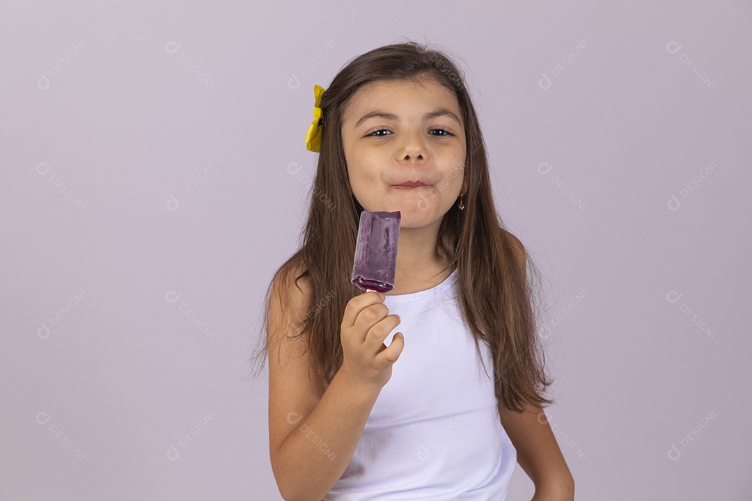 Linda Menina criança garotinha chupando picolé sobre fundo isolado branco