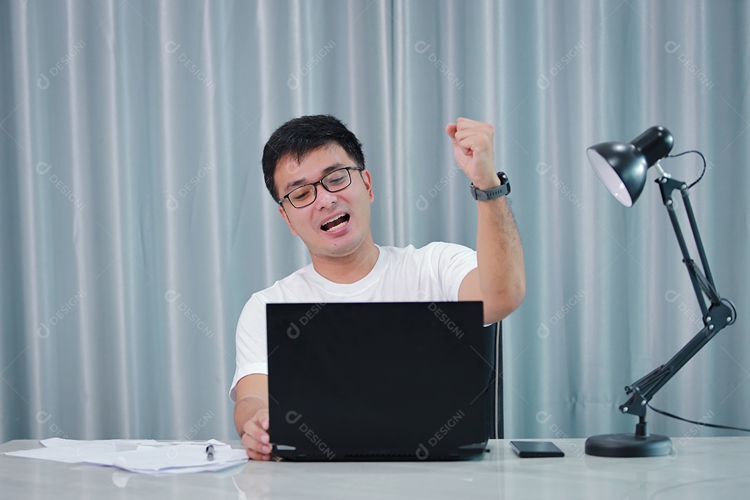 tecnologia, trabalho remoto e conceito de estilo de vida - homem asiático feliz em óculos com computador portátil trabalhando em home office ou compras on-line, trabalho em casa, freelance, aprendizado on-line, estudando.