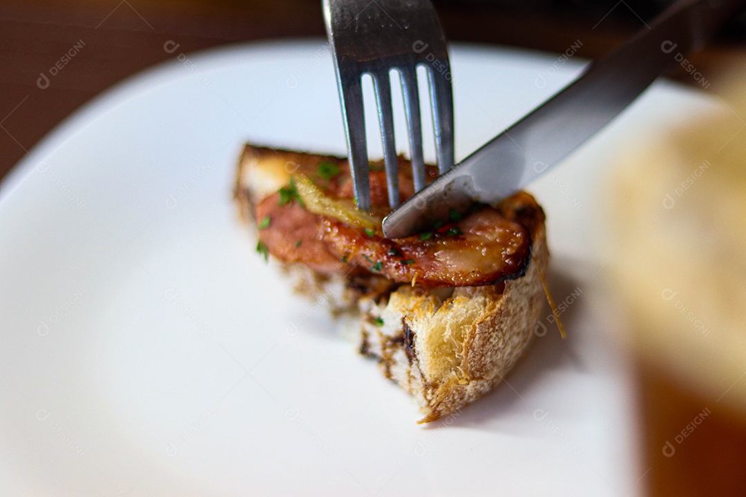 Bolo recheado de carne talheres sobre prato branco