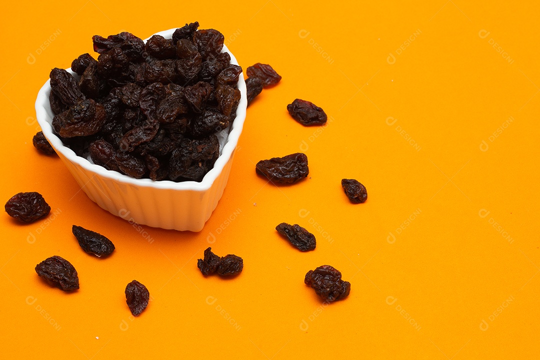 tigela cheia de passas em um fundo colorido