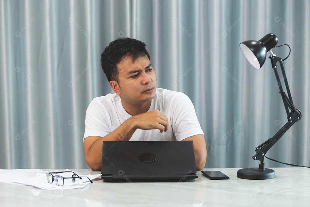 Homem jovem sobre escritório mexendo notebook