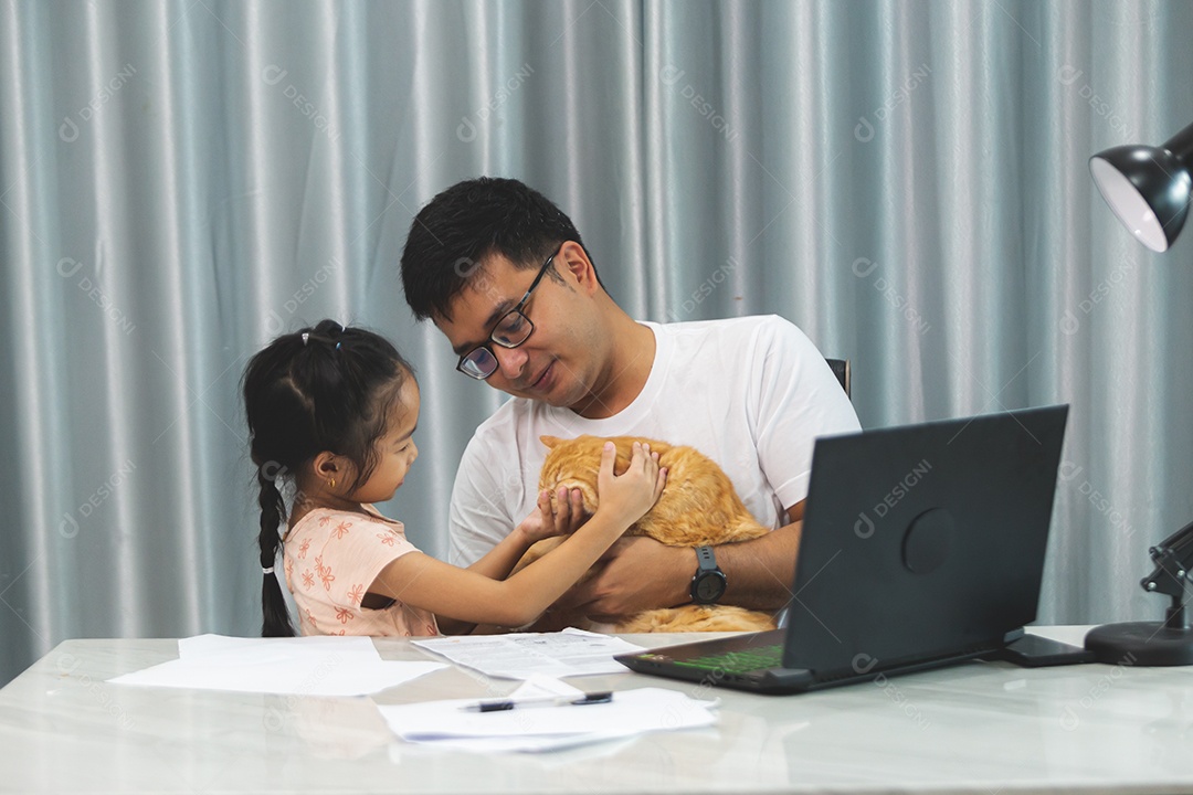 Pai e filha sobre uma mesa com seu gato de estimação