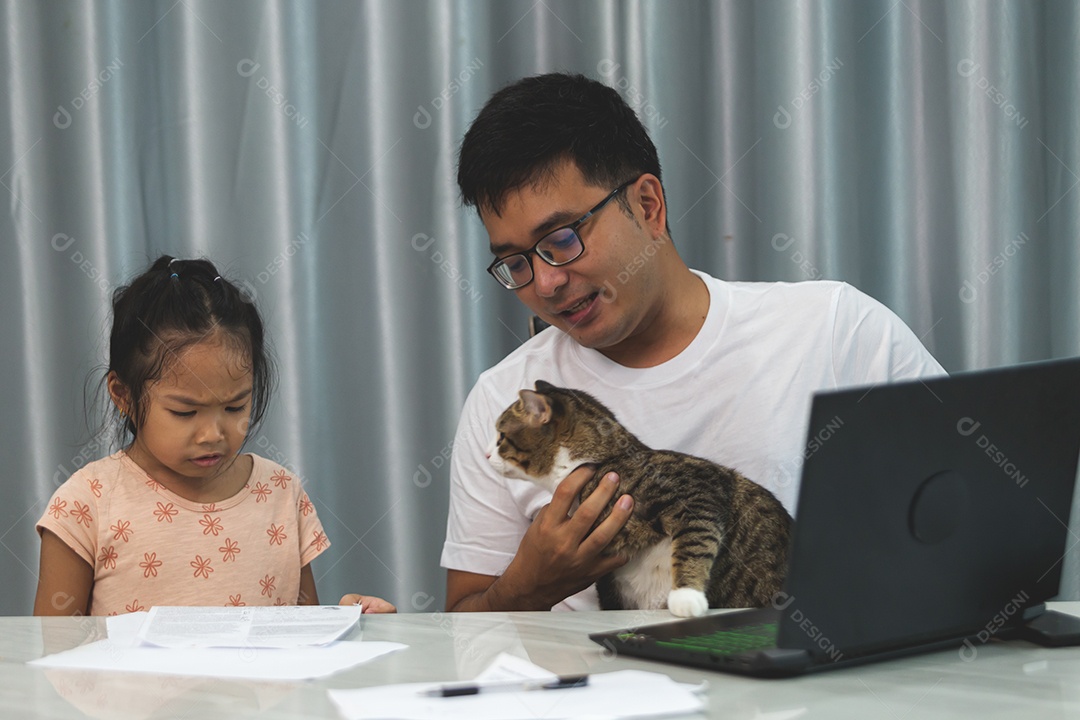 Pai e filha sobre uma mesa com seu gato de estimação