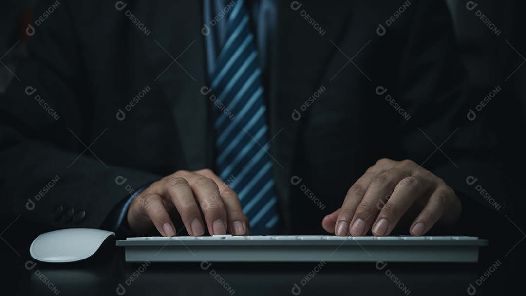 Homem de negócios usando teclado de computador na mesa.