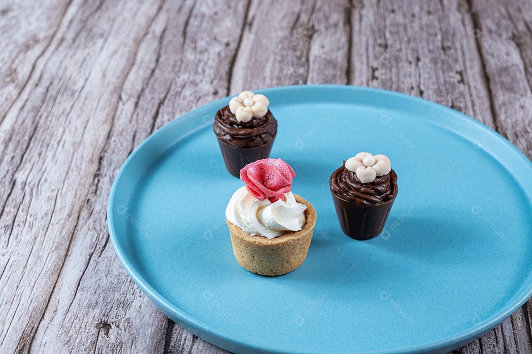 Pequenos doces sofisticados recheados com ganache de chocolate e cobertos com chantilly e fondant.