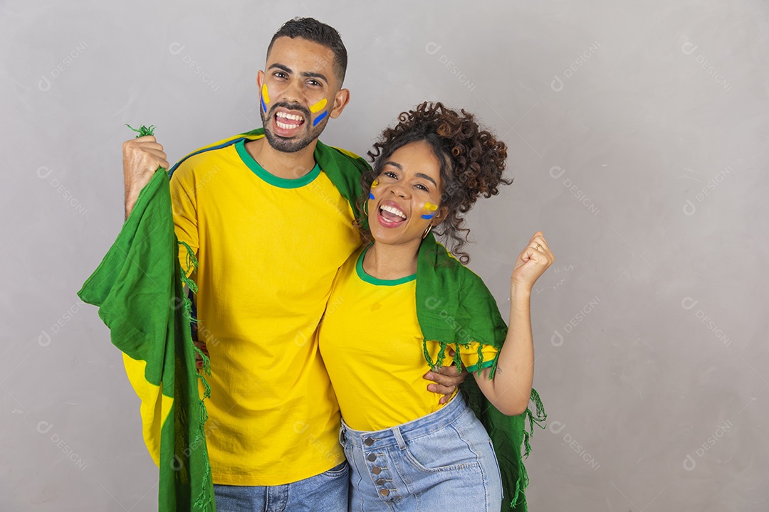 Casal jovens torcedores usando camisetas do brasil fundo isolado amarelo