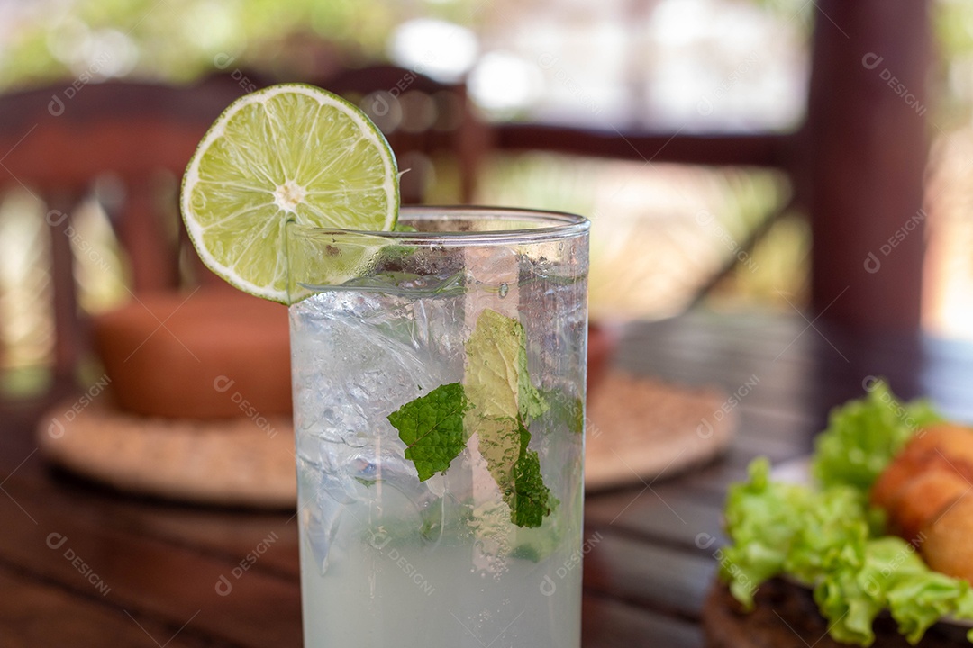 Drink de limão bebida sobre copo de vidro com gelo dentro