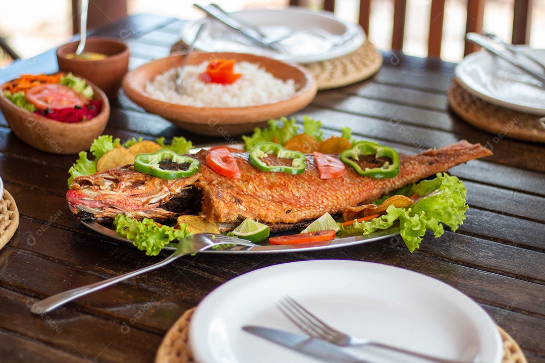Fried fish rice on a wooden table food restaurant
