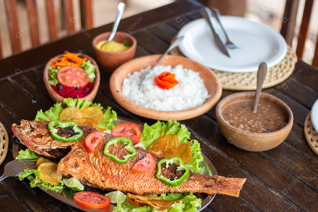 Peixe frito arroz sobre uma mesa de madeira comida restaurante