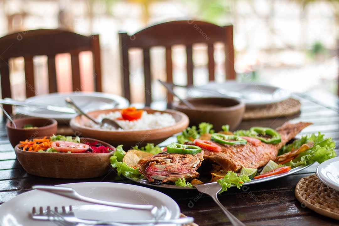 Fried fish rice on a wooden table food restaurant