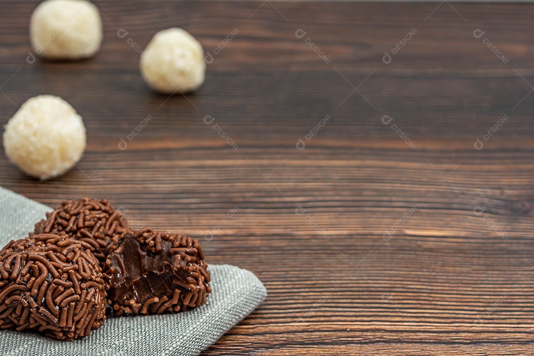 Brigadeiro brasileiro tradicional deliciosa sobremesa de chocolate, lanches de festa, vista superior de fundo polvilhado doce sobre a mesa de madeira