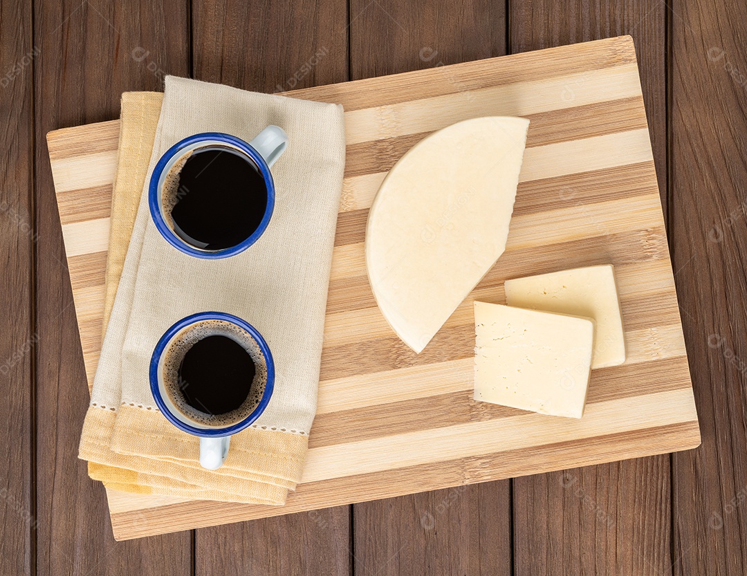 Queijo artesanal de Alagoa de Minas Gerais, Brasil sobre uma tábua de madeira com café.