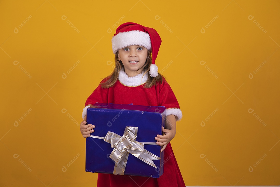 Linda menina criança segurando presentes de natal usando chapéu papai Noel