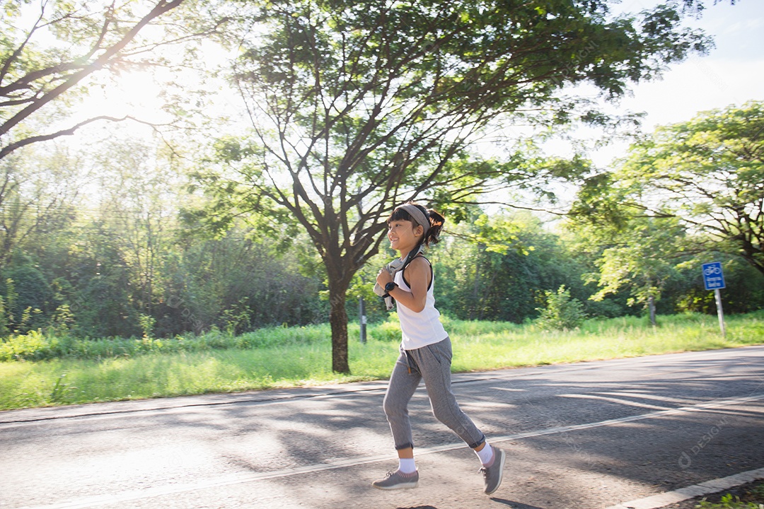 Happy child girl running in the park in summer in nature.