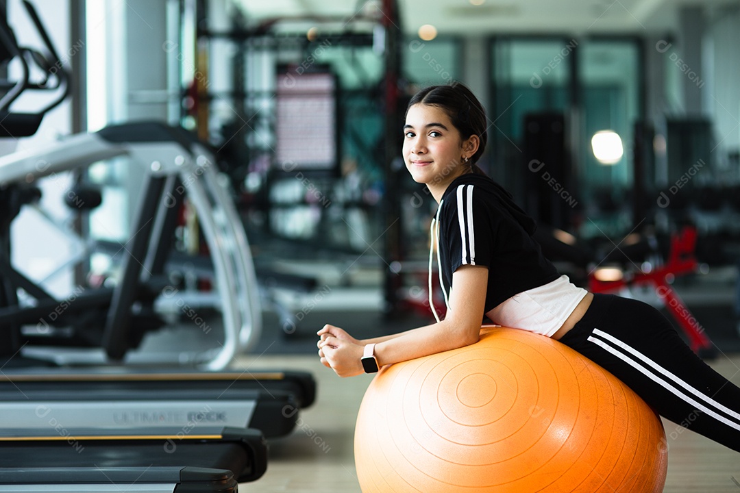 Mulher jovem e bonita desportiva. Garota malhando com bola de fitness