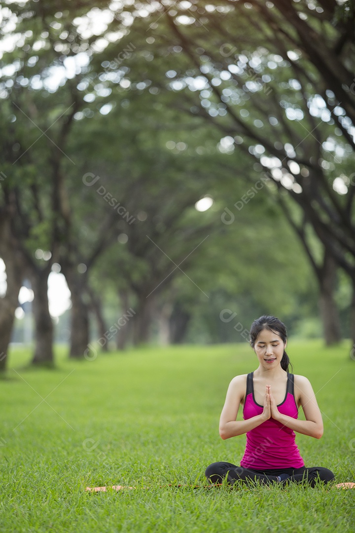 Jovem mulher praticando ioga no parque.