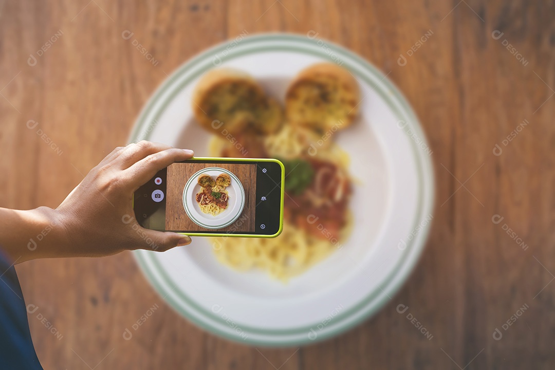 Segurando o smartphone para captura, tire uma foto de prato de comida