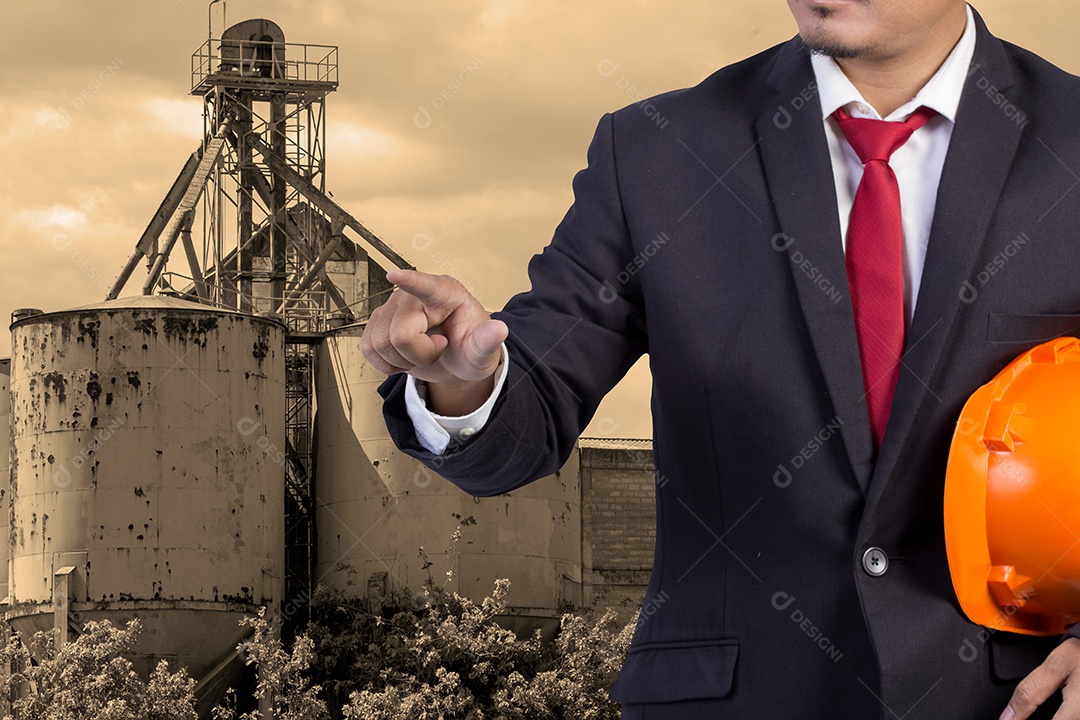 Engenheiro segurando capacete laranja para segurança dos trabalhadores.