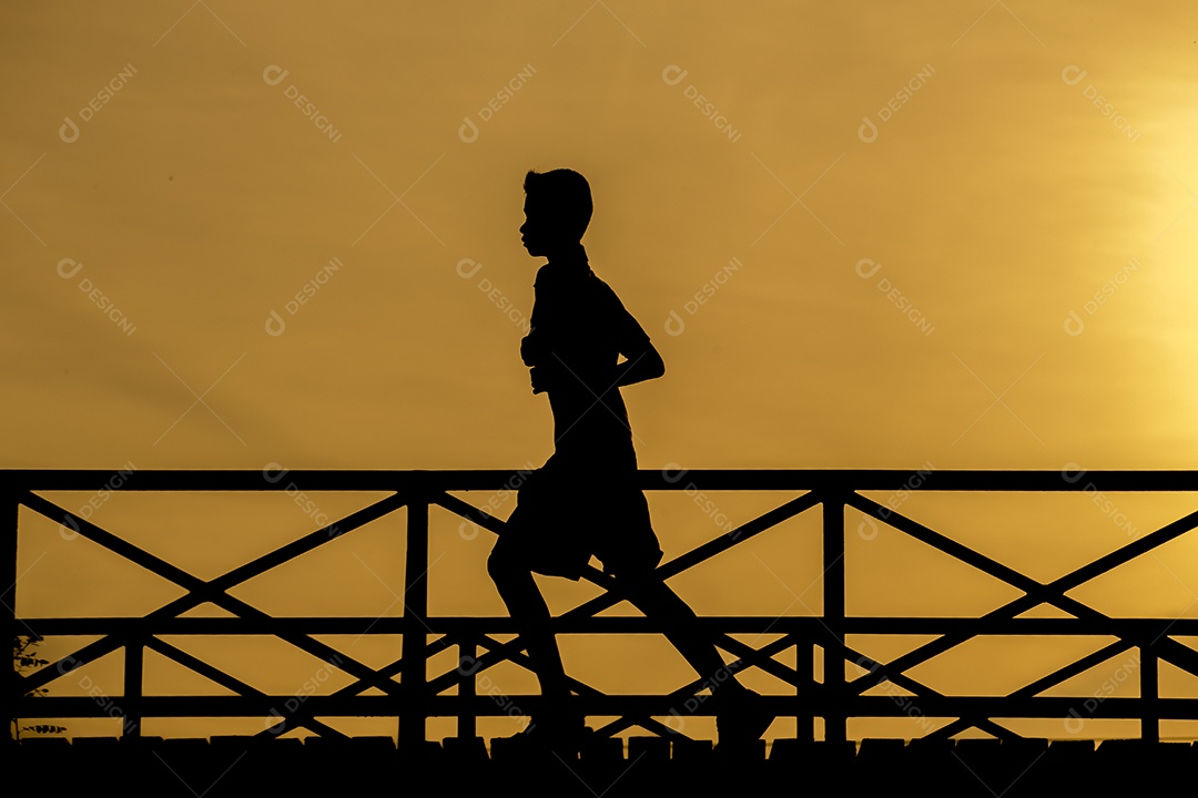 Silhouette of people running on the bridge