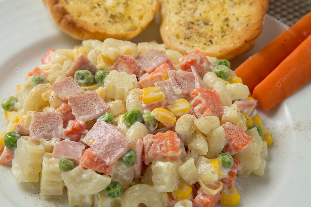 Pasta salad with mayonnaise and vegetables.