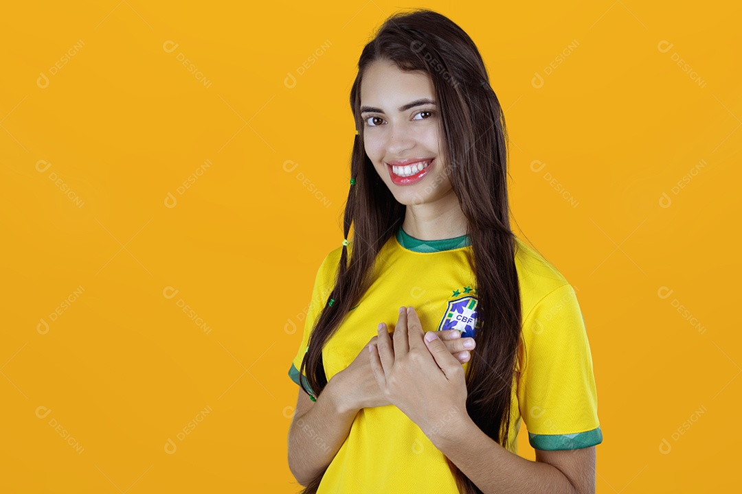 Linda mulher torcedora brasileira sobre fundo isolado amarelo