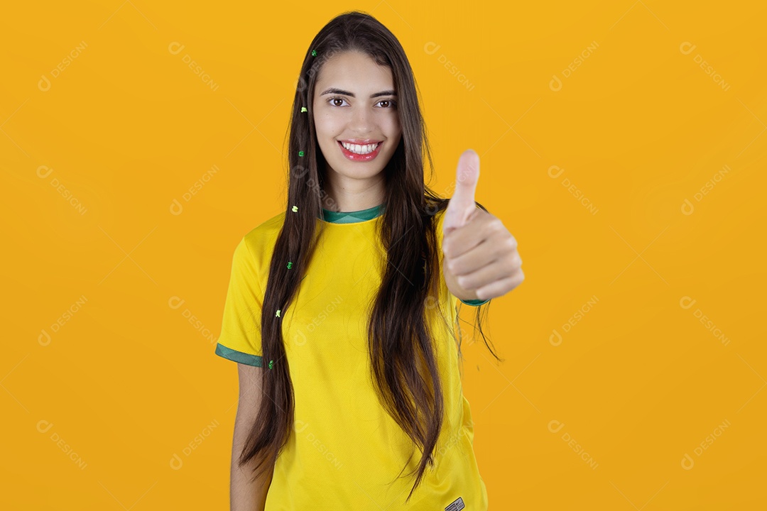 Linda mulher torcedora brasileira fazendo gestos mãos sobre fundo isolado amarelo