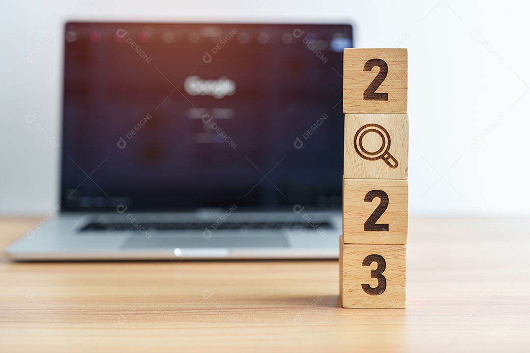 Bloco de 2023 com ícone de lupa contra o fundo do laptop.