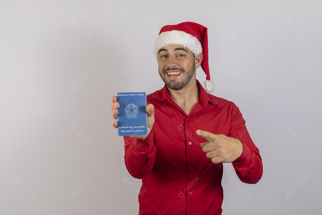 Young man wearing Santa hat holding work card over white background