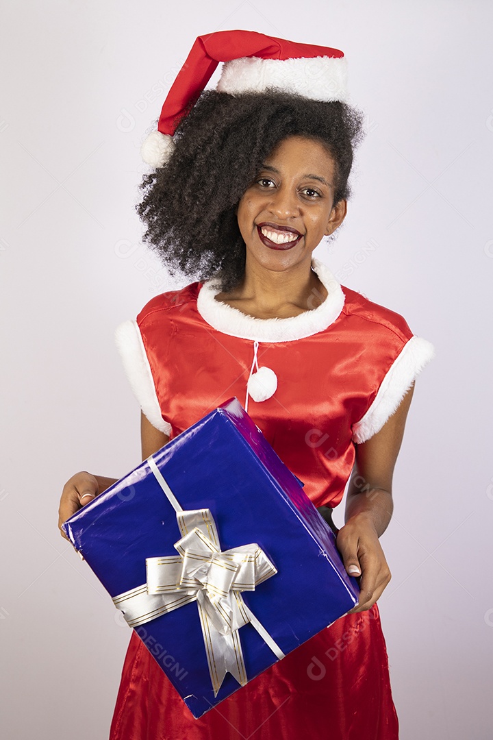 Mulher jovem usando gorro segurando caixas de presente Papai Noel sobre fundo branco