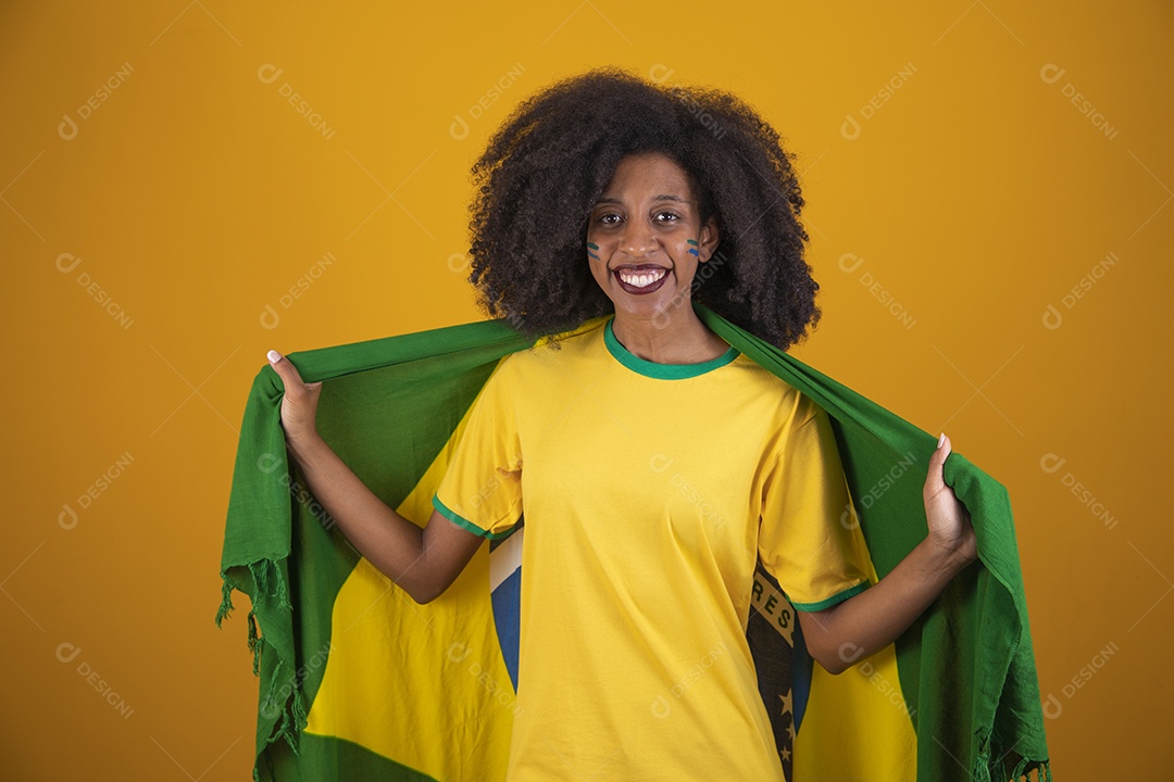 Linda mulher torcedora brasileira cabelo cacheado sobre fundo isolado amarelo