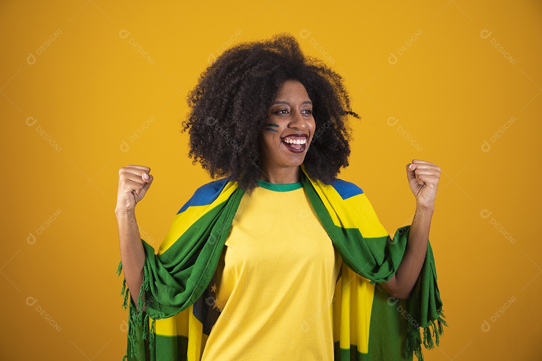 Linda mulher torcedora brasileira cabelo cacheado sobre fundo isolado amarelo
