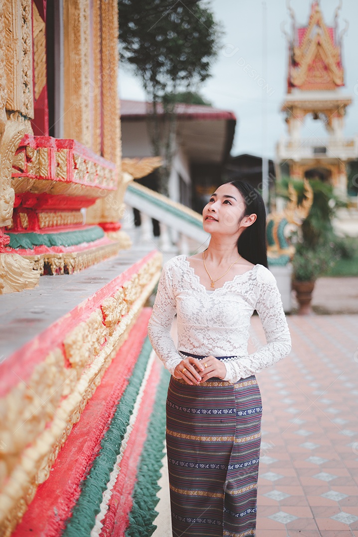 Mulher Tailandesa vestida em traje tradicional da Tailândia em templo