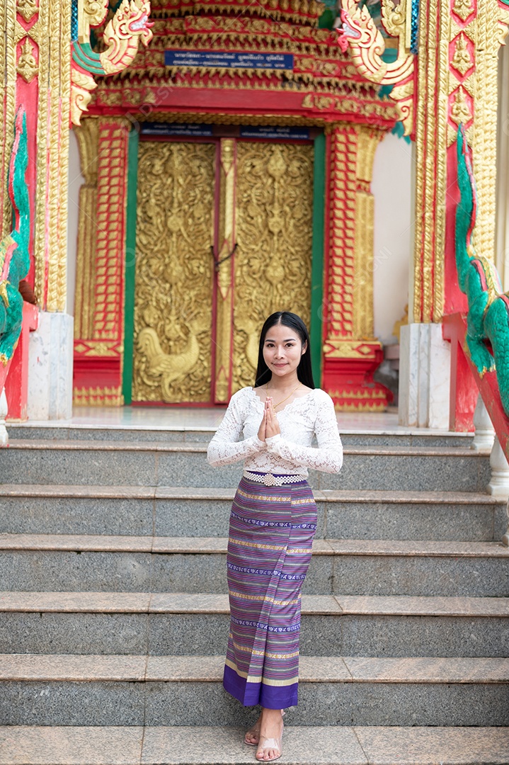 Thai woman dressed in traditional Thai costume at temple