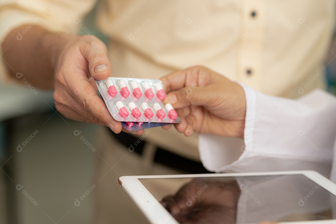 Female pharmacist handing pills to young woman in pharmacy, medical healthcare concept, close-up photo with focus on hands.