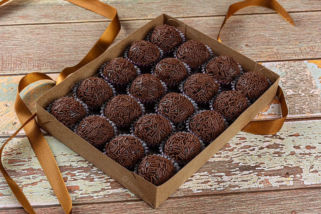 Detail of strawberry brigadeiro surrounded by traditional brigadeiros
