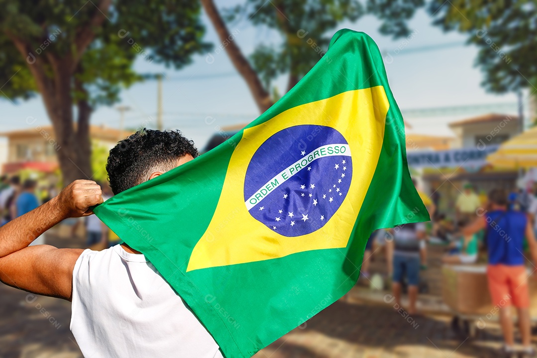 Pessoa segurando a bandeira do Brasil