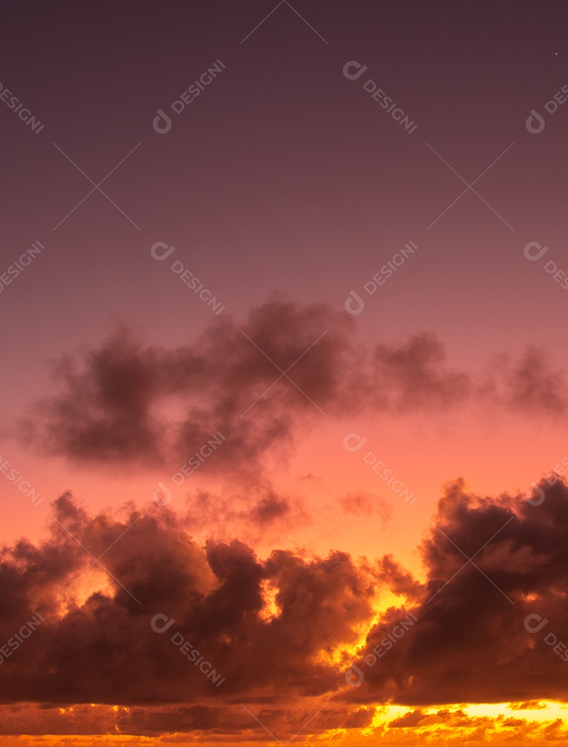 Vista do nascer do sol com nuvens dramáticas e céu colorido.