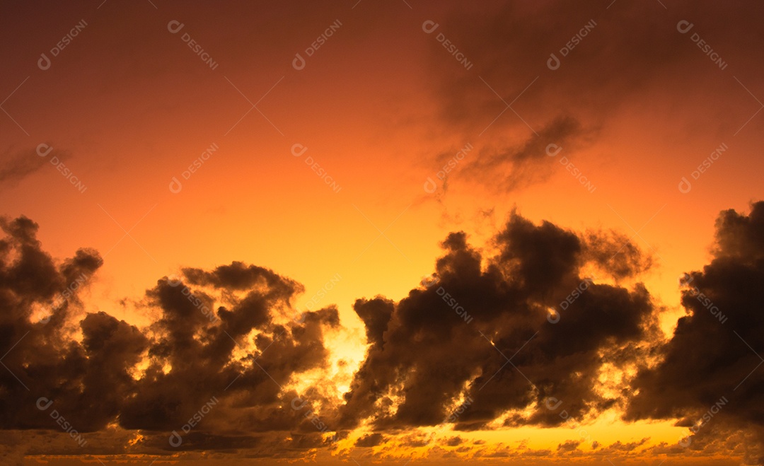 Vista do nascer do sol com nuvens dramáticas e céu colorido.