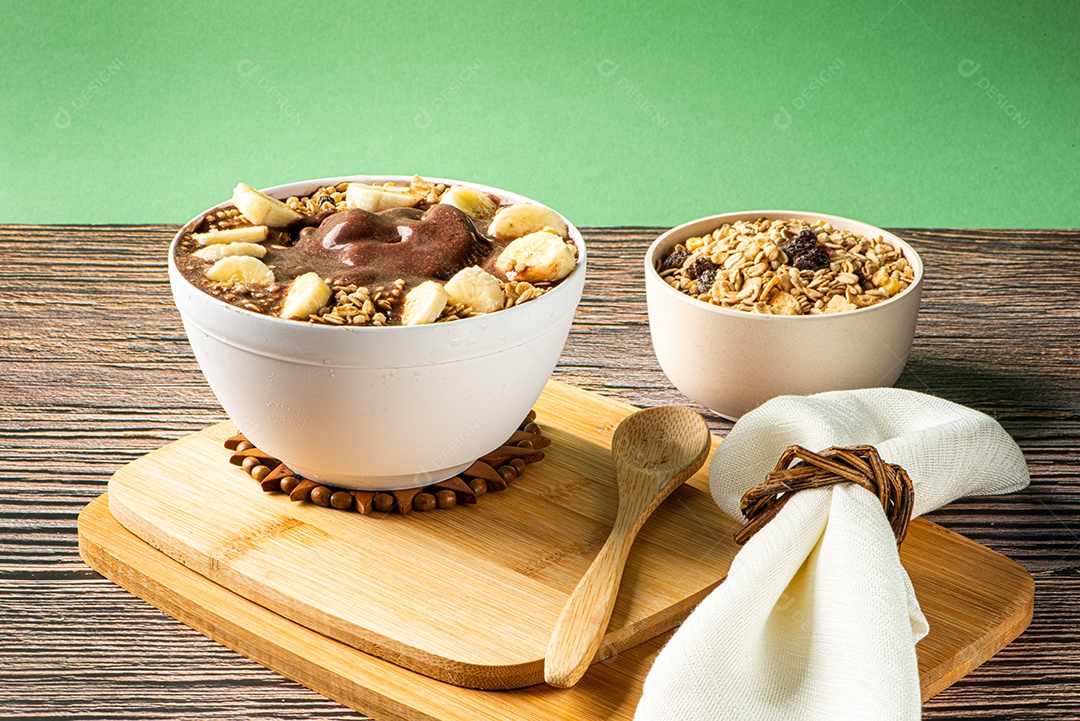 Tigela de sorvete de açaí congelado brasileiro. com frutas em fundo de madeira.